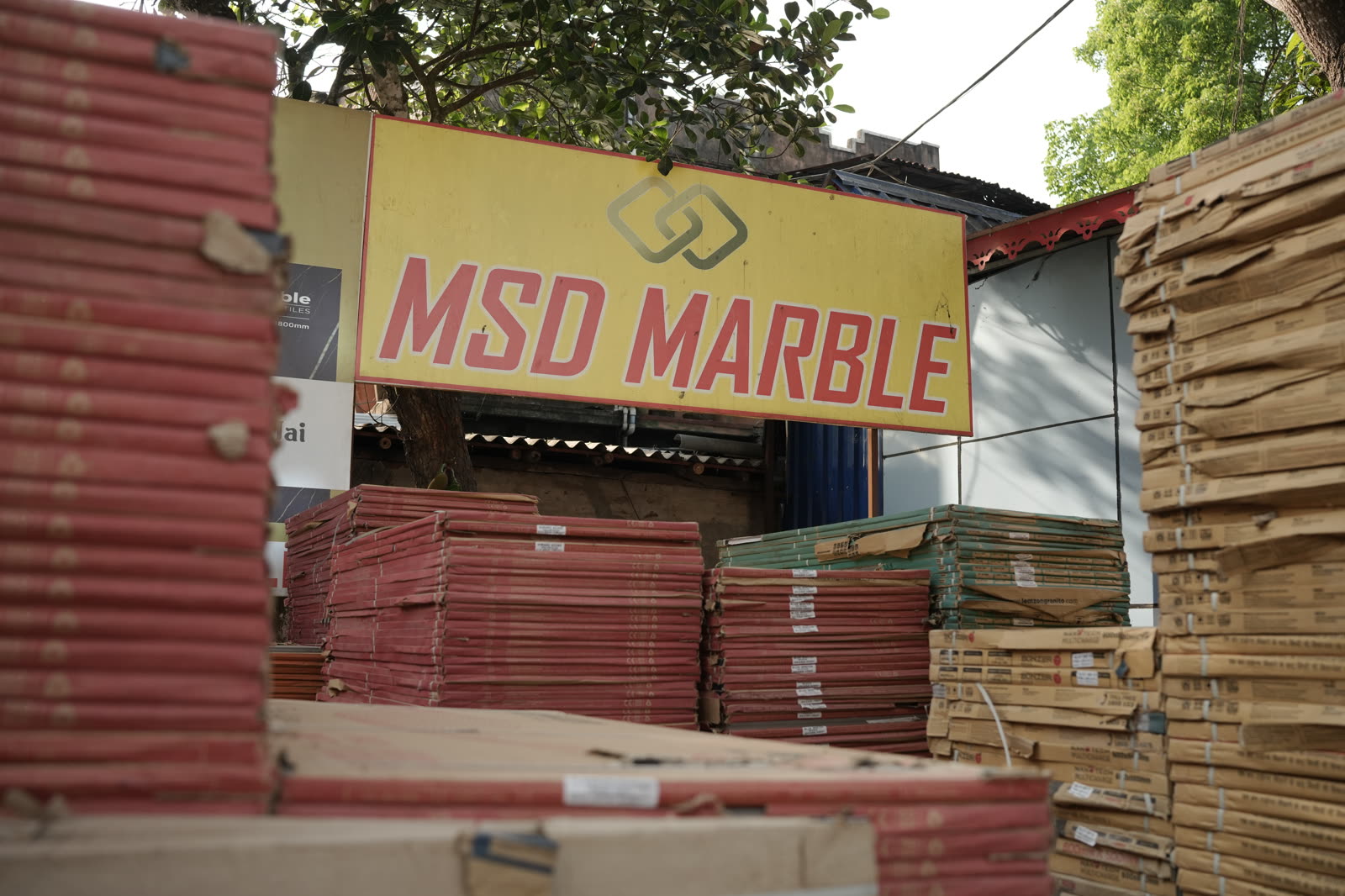 MSD Marble signboard over tile stacks in Khakurda